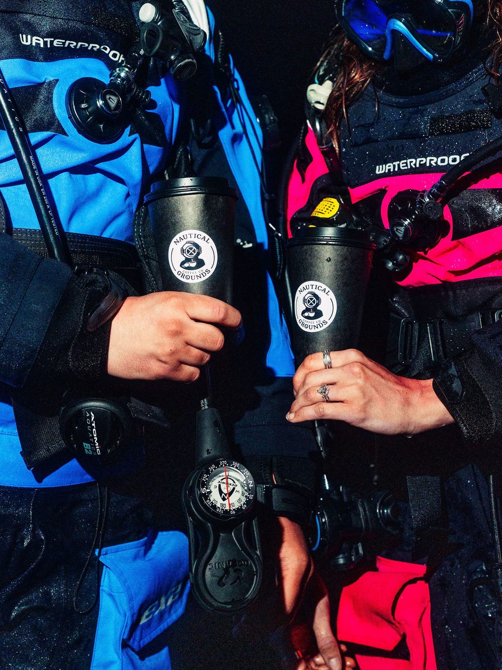 Two Nautical Grounds cups held between dive suits, regulators and a compass in frame